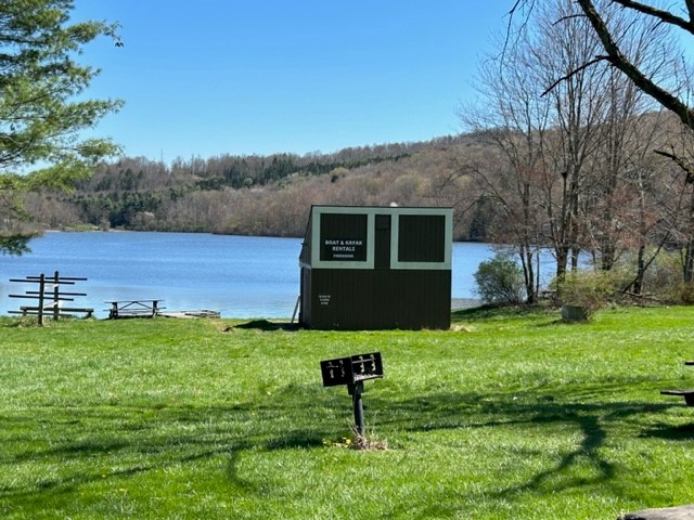 A brown boat rental shed beside Lake Lackawanna
